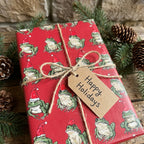Funny frog Christmas wrapping paper with a Happy Holidays gift tag, by Wrapped Studios.