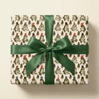 Cute frog wrapping paper with pine trees, party hats, and a green satin bow by Wrapped Studios.