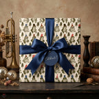Whimsical frog birthday wrapping paper with a navy blue bow and tag by Wrapped Studios.