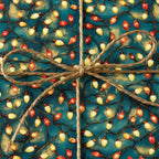 Teal Christmas gift wrap with retro string light pattern and rustic twine bow.