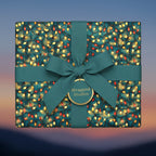 Teal Christmas gift wrap with festive string lights pattern and matching bow.