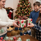 Happy young people exchanging a Christmas gift wrapped in festive ornament paper with a red and green striped bow.