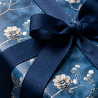 Elegant blue floral wrapping paper with navy ribbon.