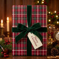 Red plaid Christmas wrapping paper with a green velvet bow and Merry Christmas tag by Wrapped Studios.