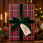 Red plaid Christmas wrapping paper with a green velvet bow and Merry Christmas tag by Wrapped Studios.