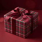 Red plaid Christmas wrapping paper with a burgundy satin bow on a holiday gift box by Wrapped Studios.