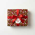 Burgundy Christmas gift wrapped in polka dot paper with a red satin bow and "A Special Gift" tag.