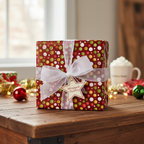 Festive Christmas gift wrapped in red dotted wrapping paper with a sheer white ribbon and star tag.