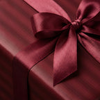 Burgundy striped wrapping paper with matching satin ribbon for an elegant gift.