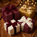 Elegant gift boxes wrapped in striped burgundy and gold paper, adorned with velvet and satin ribbons for luxury gift wrap.