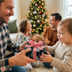 Boy receiving a gift wrapped in snowman Christmas wrapping paper with red striped ribbon by Wrapped Studios.