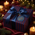 Elegant Christmas gift wrap with navy ribbon on a present with a "Season's Greetings" tag.