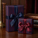 Elegant striped wrapping paper in navy and burgundy with satin ribbon bows.