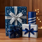 Elegant gifts wrapped in blue floral wrapping paper with silver and velvet ribbon for Christmas or birthday.
