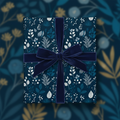 Navy blue floral wrapping paper with velvet ribbon, elegant botanical gift wrap.