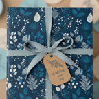 Navy floral wrapping paper with blue ribbon and "Wishing You Joy" tag.