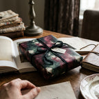 Moody floral wrapping paper with black ribbon and "to my inspiration" tag, from Wrapped Studios.