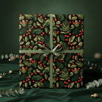 Elegant Christmas gift wrapped in black floral wrapping paper with red berries and green ribbon.