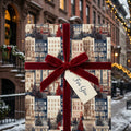 Christmas wrapping paper featuring a winter brownstone print and red velvet ribbon by Wrapped Studios.