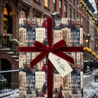 Christmas wrapping paper featuring a winter brownstone print and red velvet ribbon by Wrapped Studios.