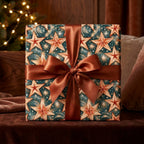 Elegant teal and gold star Christmas gift wrap with a bronze satin bow by Wrapped Studios.