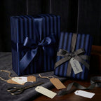 Elegant navy blue striped wrapping paper with ribbon and gift tags for congratulations.