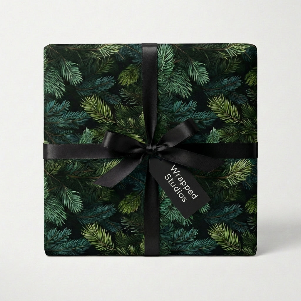 Evergreen Colorado spruce Christmas wrapping paper on gift box with rustic pattern and black ribbon on a white background