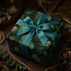 Elegant Christmas gift wrap with teal ribbon on a square box, featuring a dark green evergreen tree branch pattern.