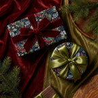 Elegant Christmas gift wrap with red berry and leaf pattern, velvet ribbon.