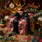 Elegant floral Christmas gift wrap with black ribbon by Wrapped Studios.