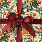 Close-up of a Christmas gift wrapped in floral holiday paper with a burgundy satin bow.
