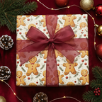 Square gift wrapped in festive gingerbread-patterned Christmas wrapping paper with sheer burgundy ribbon.