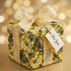 Wrapped gift in yellow floral wrapping paper with sheer gold ribbon and "For You" tag.