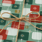 Retro Christmas gift wrap with mid-century modern starburst pattern and rustic twine bow.