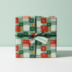 Retro-style gift wrapped in geometric holiday wrapping paper with green ribbon and a "Special Gift" tag.