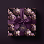 Elegant Christmas wrapping paper with purple ornament design and satin ribbon from Wrapped Studios.