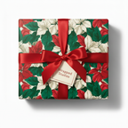 Elegant Christmas gift wrapped in red and white poinsettia floral wrapping paper with a satin ribbon.