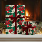 Two gifts wrapped in poinsettia floral Christmas wrapping paper with velvet ribbon.