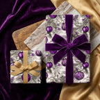 Elegant Christmas gift wrap featuring purple ornaments and velvet ribbon bows.
