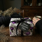 "Merry Christmas Mom" gift wrapped in vintage-style purple ornament Christmas wrapping paper with black velvet ribbon.