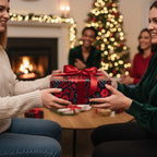 Christmas gathering with floral wrapping paper gift exchange, red ribbon on box.