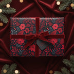 Elegant Christmas gift wrapped in floral wrapping paper with a red velvet bow.