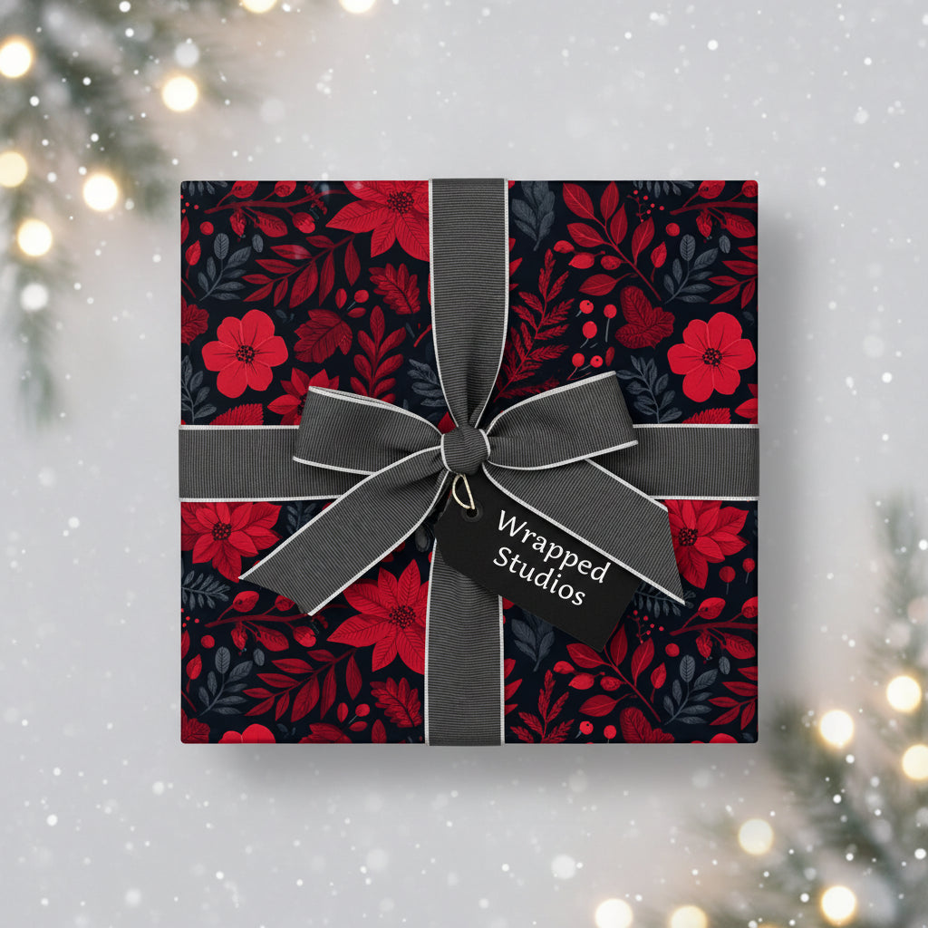 Elegant Christmas gift wrapped in red poinsettia floral paper with a gray ribbon and bow.