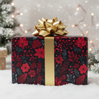 Elegant Christmas gift wrap with a dark floral pattern, gold ribbon, and bow.
