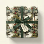 Vintage winter wonderland wrapping paper: snowy forest, rustic cabins, red berries. Dark green ribbon by Wrapped Studios.