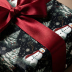 Christmas gift wrapped in wintery snowman wrapping paper with a red satin bow.