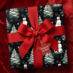 Christmas gift wrapped in snowmen print paper with a bright red grosgrain ribbon and bow.