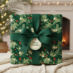 Elegant square gift box wrapped in festive floral Christmas gift wrap with a dark green ribbon and bow.