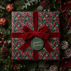 Luxury Christmas gift wrap: Floral leaf pattern with red velvet ribbon and "Season's Greetings" tag.