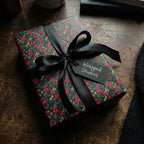 Wrapped Studios gift with vintage floral wrapping paper, tied with a black satin ribbon and tag.